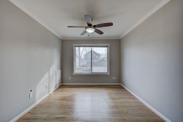 unfurnished room featuring crown molding, ceiling fan, and light wood-type flooring