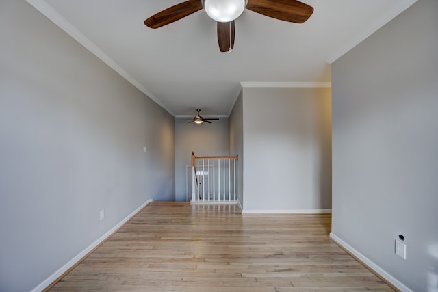 spare room featuring crown molding, light hardwood / wood-style floors, and ceiling fan