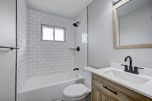 full bathroom featuring tiled shower / bath, vanity, and toilet