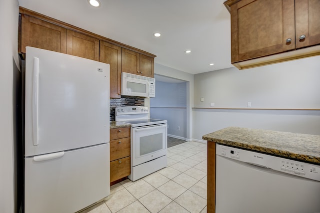 kitchen featuring tasteful backsplash, white appliances, and light tile patterned flooring