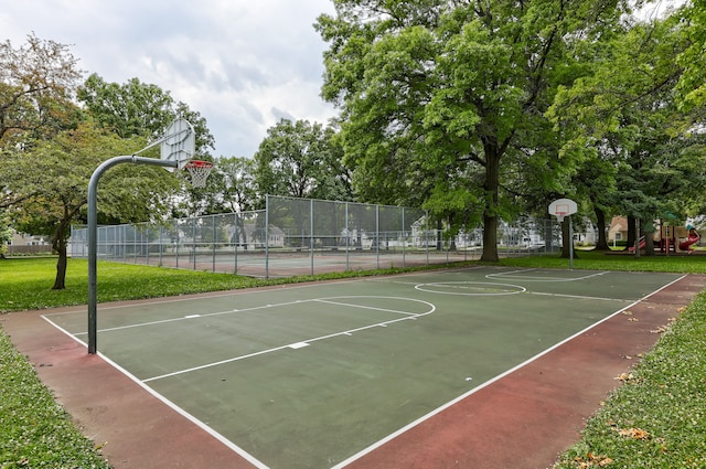 view of sport court featuring a playground and tennis court