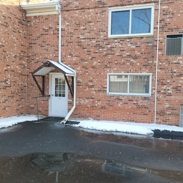 view of snow covered property entrance