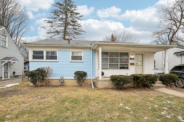 rear view of property featuring a yard