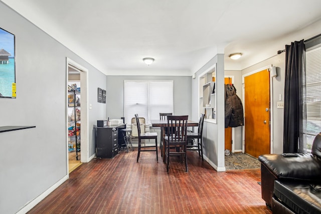 dining space with dark wood-type flooring and plenty of natural light