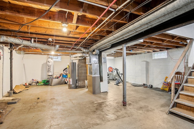 basement featuring gas water heater and heating unit