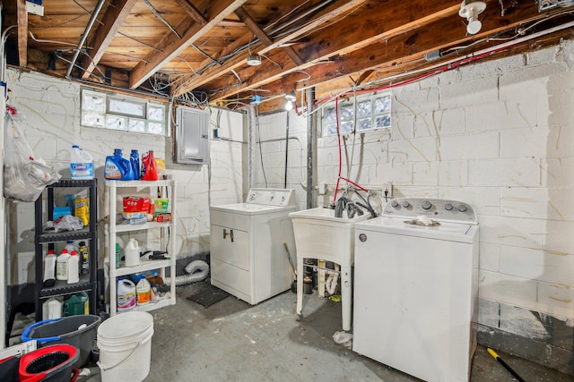 basement featuring electric panel and washing machine and dryer