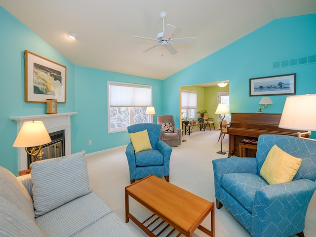 carpeted living room with lofted ceiling and ceiling fan