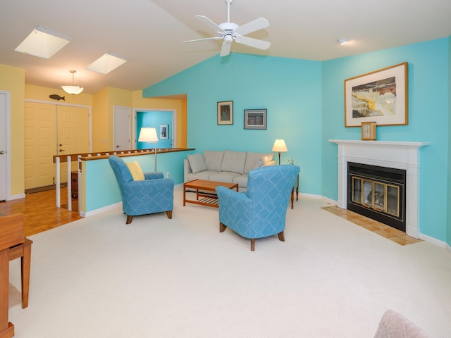 carpeted living room featuring vaulted ceiling with skylight