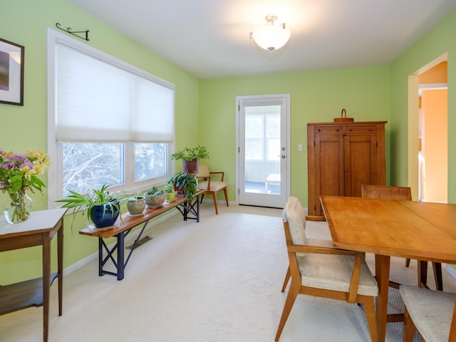 carpeted dining space featuring plenty of natural light