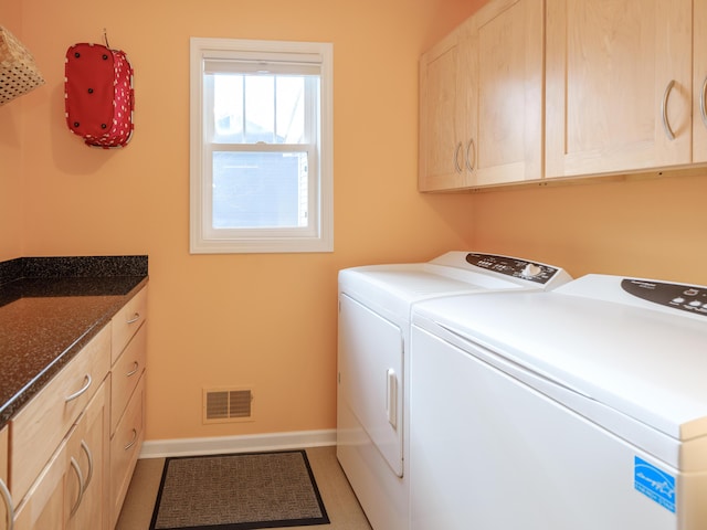 laundry area featuring cabinets and washer and clothes dryer