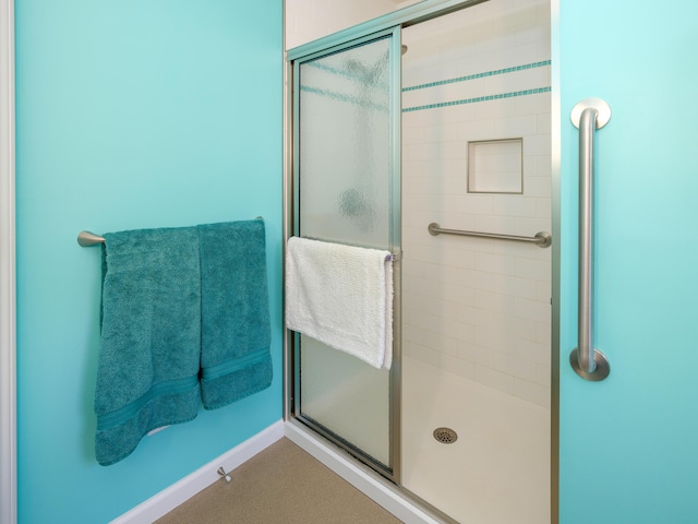 bathroom with a shower with door