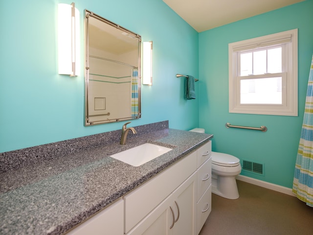 bathroom featuring vanity and toilet