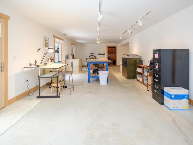 game room featuring concrete flooring and rail lighting