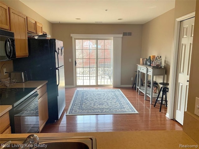 kitchen with electric stove and light hardwood / wood-style floors