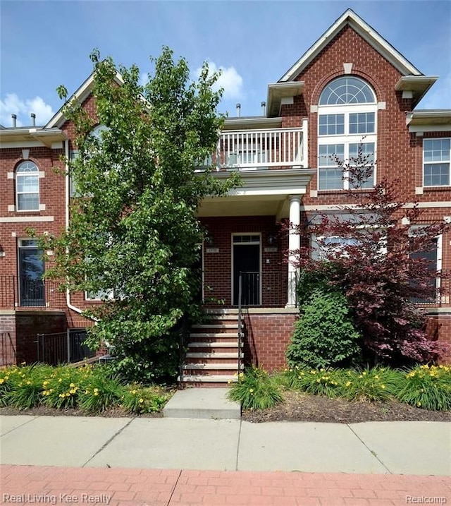 view of front of house featuring a balcony