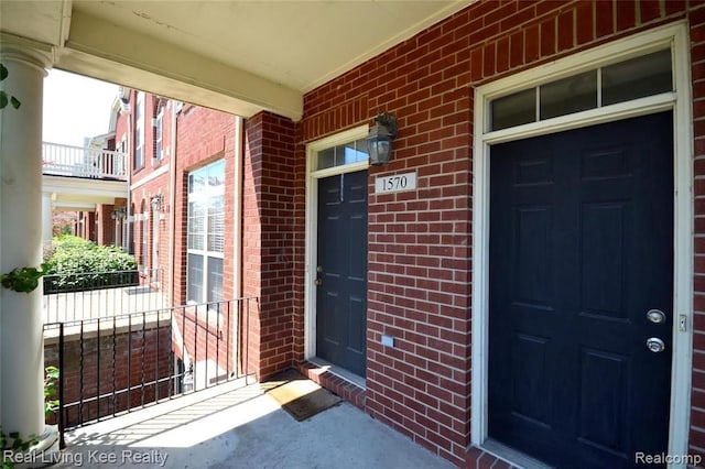 view of exterior entry with a porch