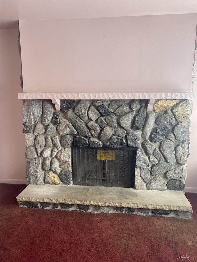 interior details featuring a fireplace and carpet floors