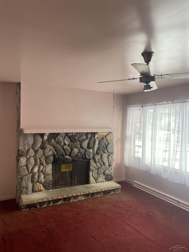 details featuring a stone fireplace, carpet floors, ceiling fan, and baseboard heating