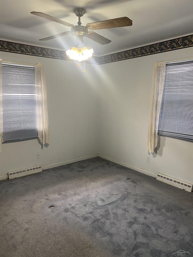 unfurnished room featuring a baseboard heating unit, a wealth of natural light, and carpet floors