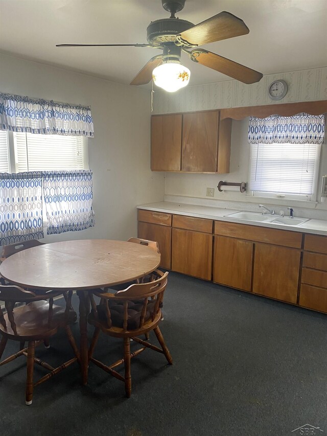 unfurnished dining area with ceiling fan and sink