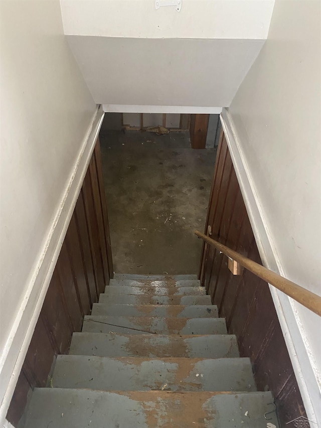 stairs featuring concrete flooring