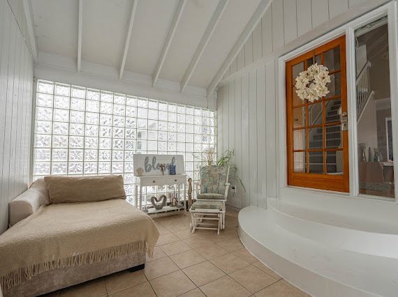 sunroom with vaulted ceiling with beams and plenty of natural light