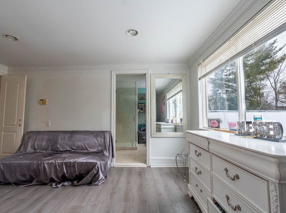 sitting room with ornamental molding, baseboards, and wood finished floors