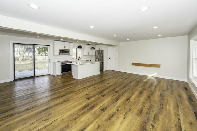 unfurnished living room with dark wood-type flooring