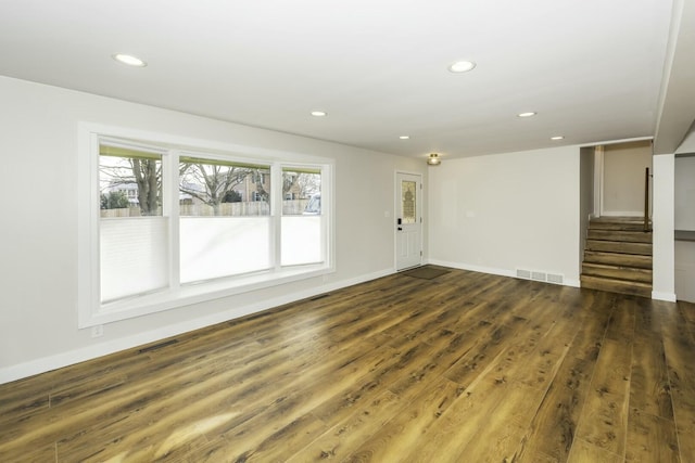 spare room with dark wood-type flooring