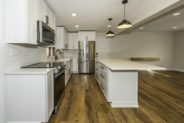 kitchen featuring sink, appliances with stainless steel finishes, white cabinetry, hanging light fixtures, and dark hardwood / wood-style flooring