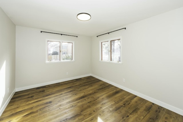 unfurnished room featuring dark wood-type flooring