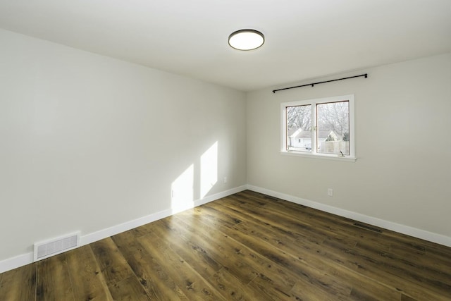 spare room featuring dark hardwood / wood-style floors