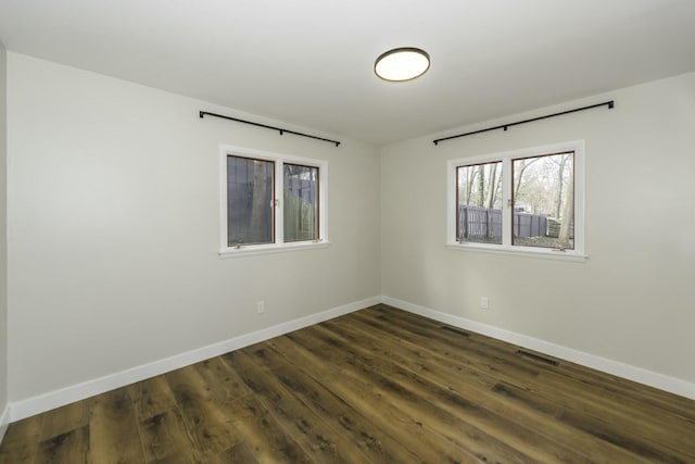 spare room featuring dark wood-type flooring