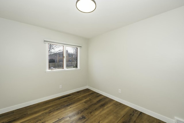 empty room featuring dark wood-type flooring