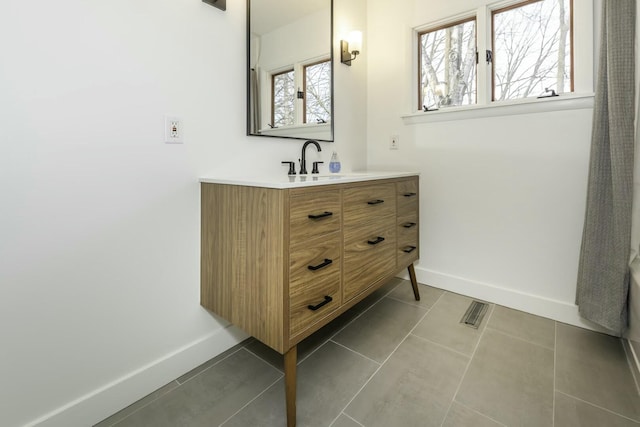 bathroom with tile patterned floors and vanity