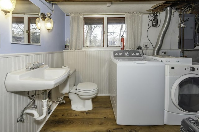 laundry area with sink, dark hardwood / wood-style floors, and washer and dryer