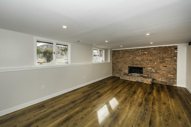 unfurnished living room featuring a fireplace and dark hardwood / wood-style flooring