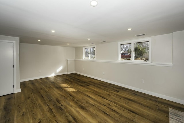 basement with dark hardwood / wood-style flooring