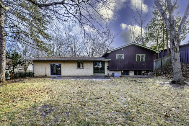 back of house with a patio and a yard