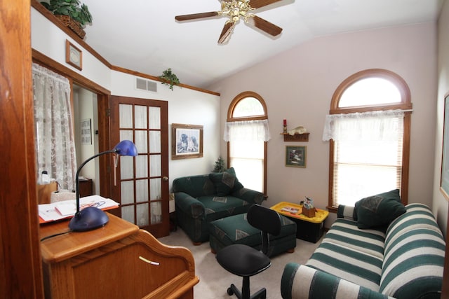 living room featuring ceiling fan, lofted ceiling, and light carpet