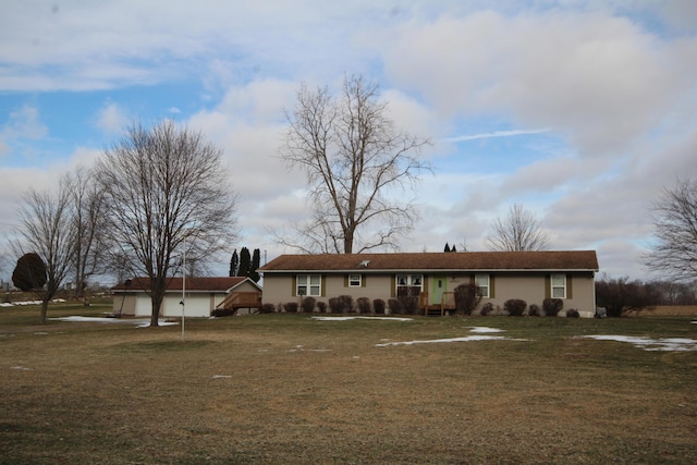 ranch-style house featuring a garage and a front lawn