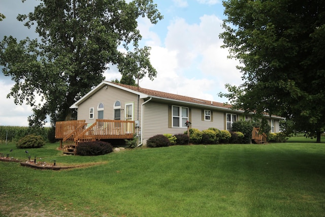 view of front of house featuring a wooden deck and a front lawn