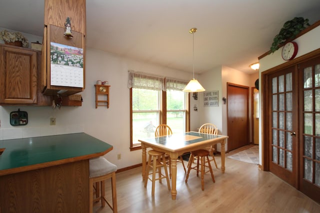 14523 E V Ave, Fulton, MI 49052 - dining area with french doors, light wood finished floors, and baseboards