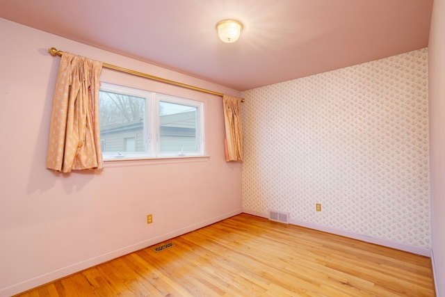 unfurnished room featuring hardwood / wood-style flooring