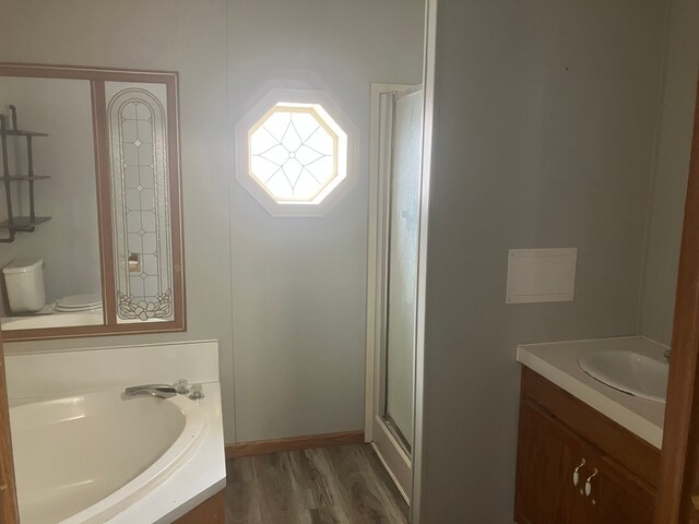 full bathroom with vanity, toilet, independent shower and bath, and wood-type flooring