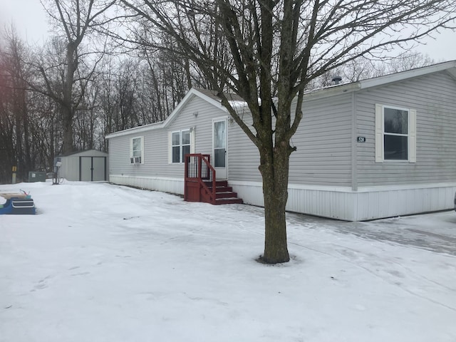 manufactured / mobile home featuring an outbuilding and a shed