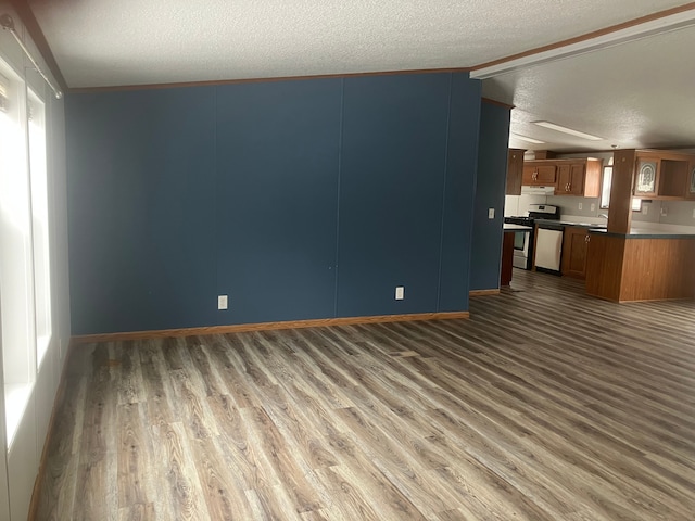 unfurnished living room with dark wood-style flooring and a textured ceiling