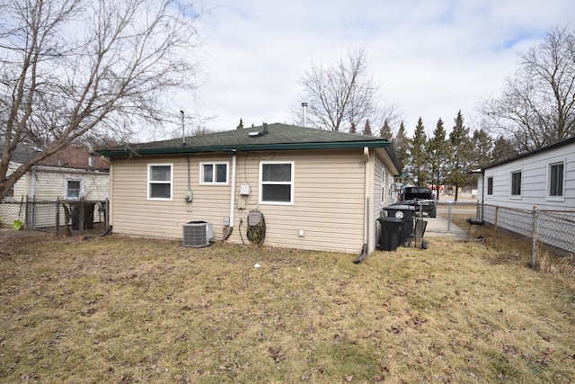 back of house featuring a yard and a fenced backyard