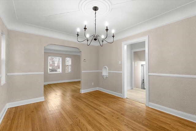 unfurnished dining area with hardwood / wood-style flooring and crown molding