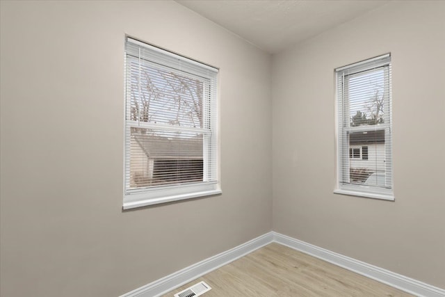 spare room featuring hardwood / wood-style floors